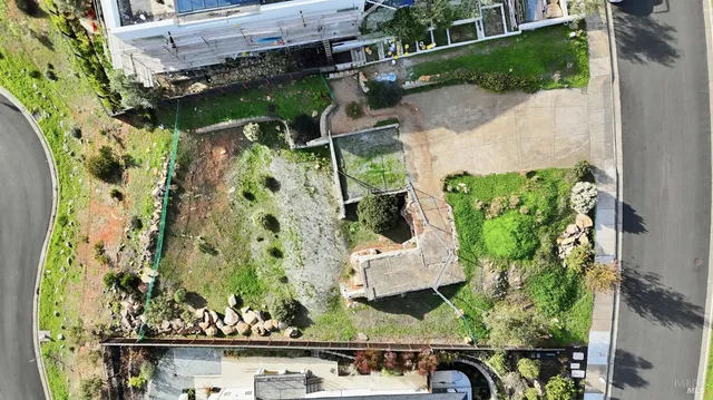 an aerial view of a residential houses with outdoor space