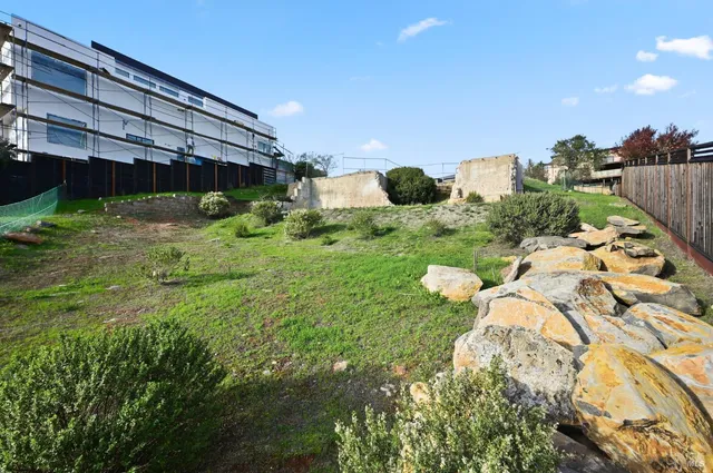 a backyard of a house with a yard and outdoor seating