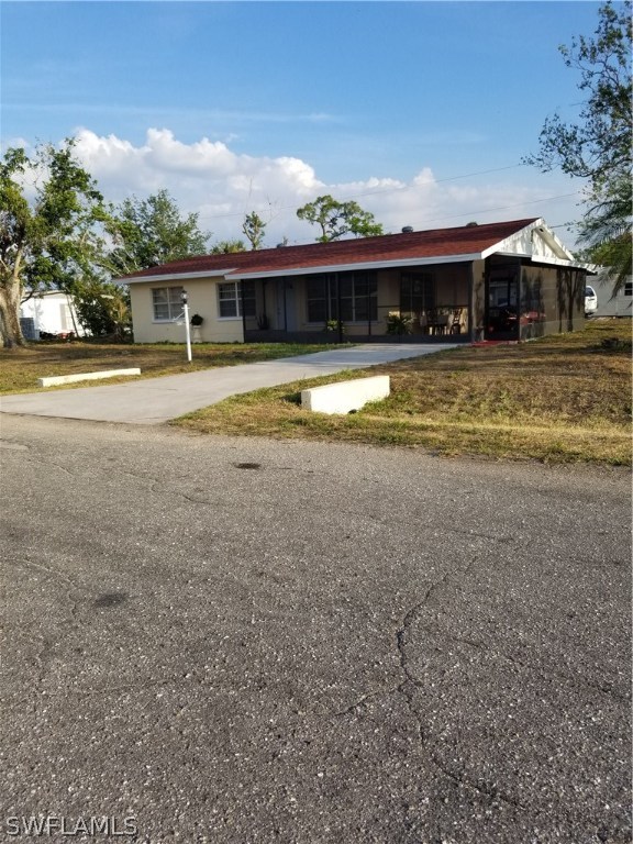 102 Oregon Road West Lehigh Acres, FL 33936 - Photo 3 of 25 a view of house with swimming pool and outdoor seating