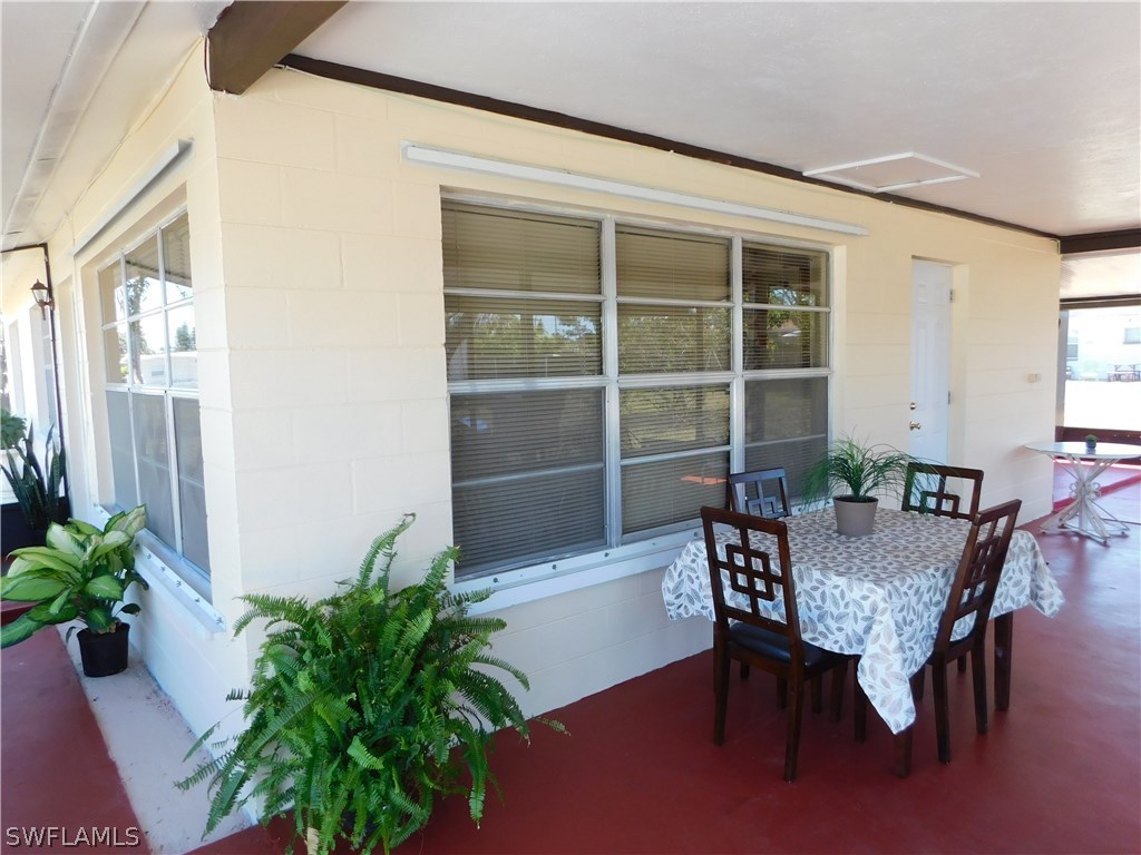 102 Oregon Road West Lehigh Acres, FL 33936 - Photo 4 of 25 a view of a dining room with furniture and window