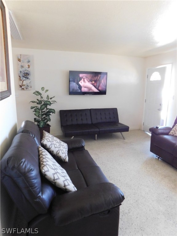 102 Oregon Road West Lehigh Acres, FL 33936 - Photo 10 of 25 a living room with furniture and a couch