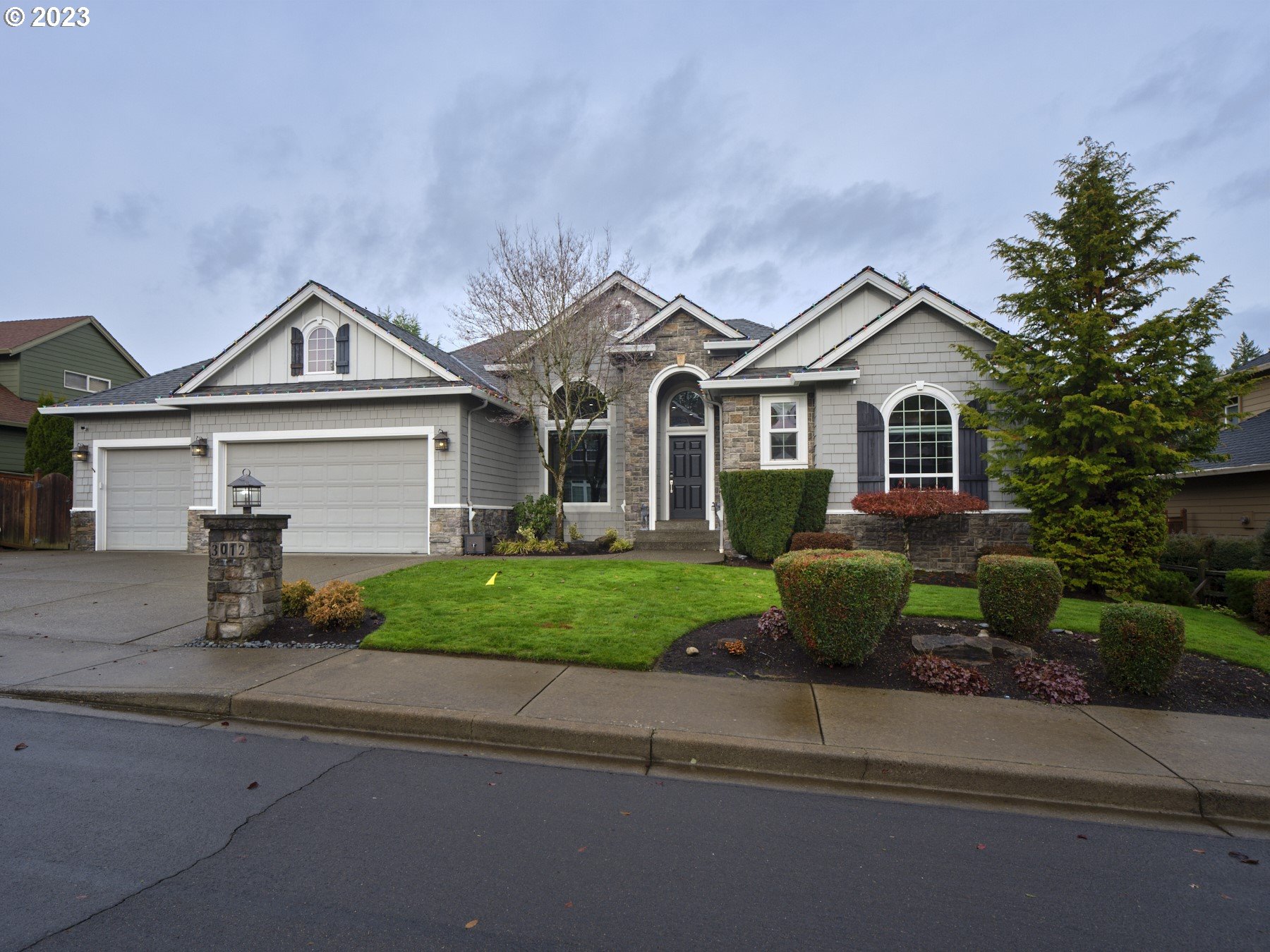 3012 Northeast 173rd Street Ridgefield, WA 98642 - Photo 1 of 32 a front view of a house with a garden and plants