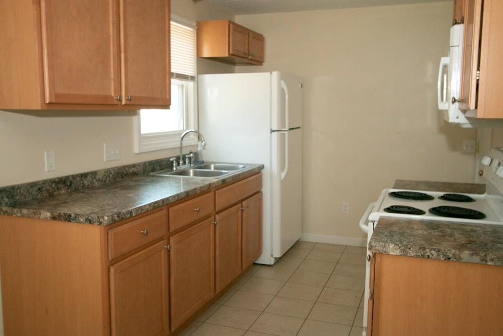 24 Tumbleweed Road Springfield, MA 01109 - Photo 6 of 31 a kitchen with stainless steel appliances granite countertop a sink stove and refrigerator