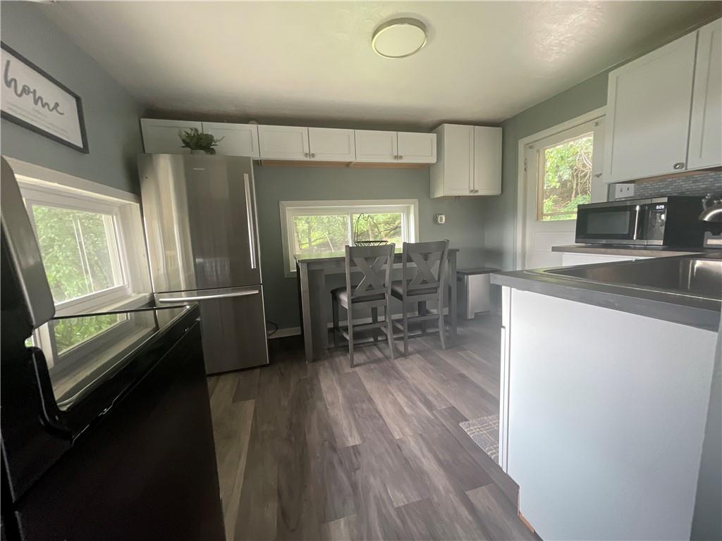 500 7th Avenue Freedom, PA 15042 - Photo 21 of 21 a kitchen with stainless steel appliances a dining table chairs refrigerator and sink