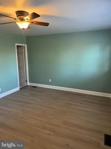 an empty room with wooden floor
