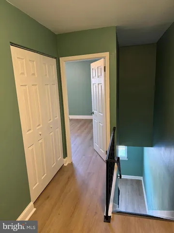 an empty room with wooden floor and closet