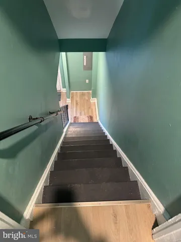 a kitchen with granite countertop a refrigerator and a stove top oven