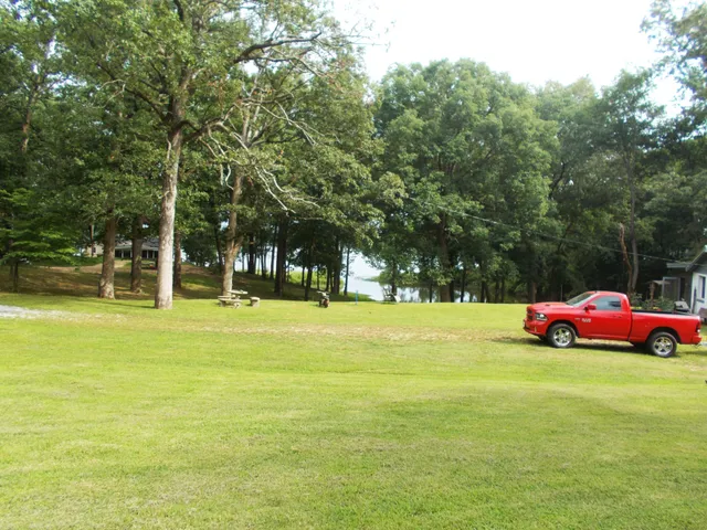 a view of yard with swimming pool and green space