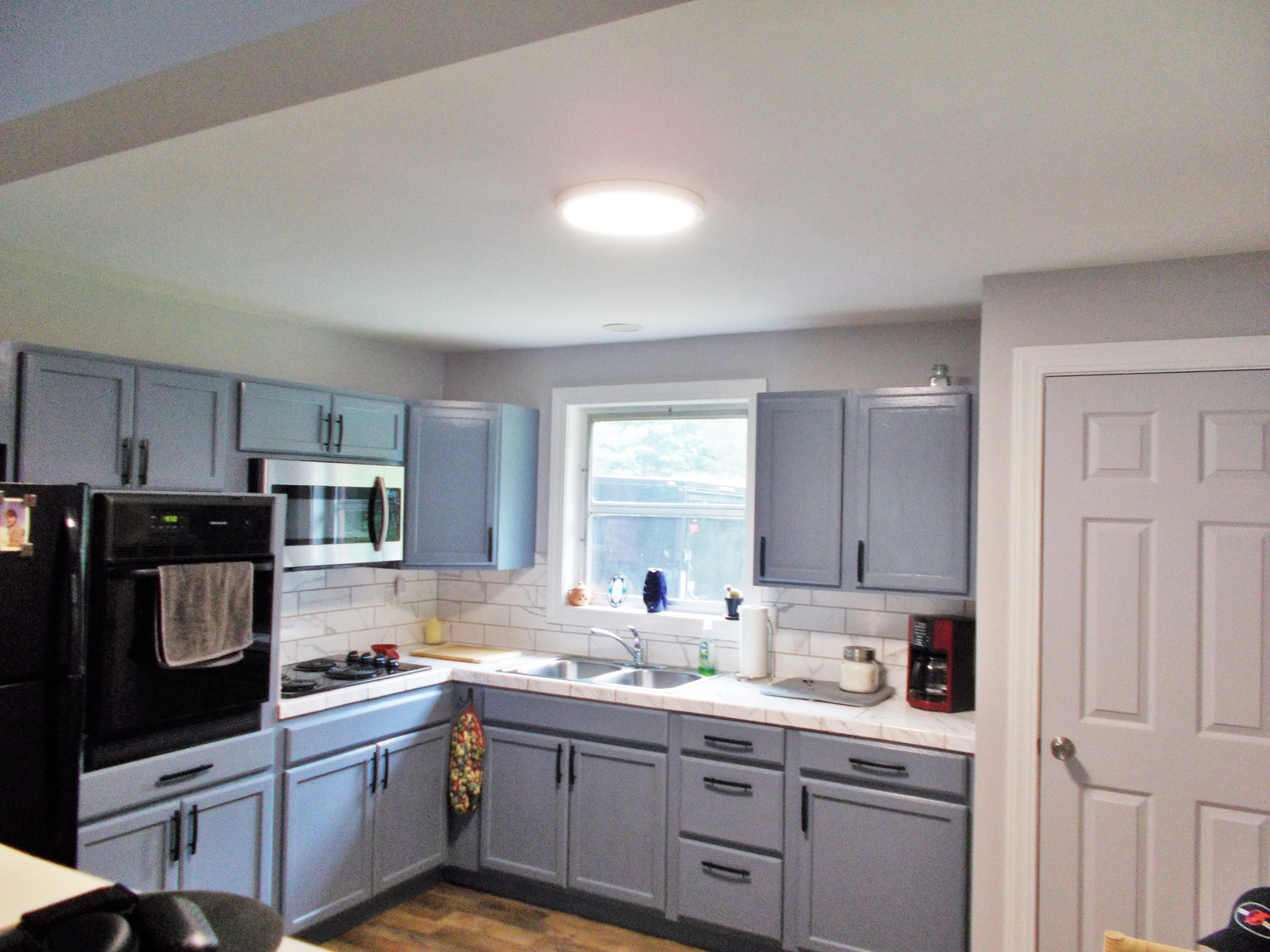 979 Highlander Road Camden, TN 38320 - Photo 2 of 23 a kitchen with kitchen island granite countertop a sink cabinets and stainless steel appliances