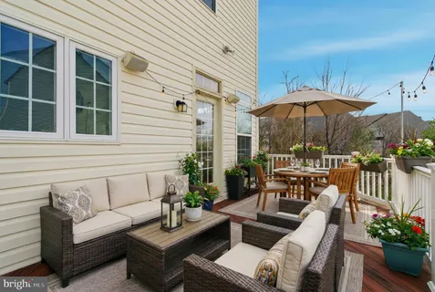a view of a patio with couches under an umbrella