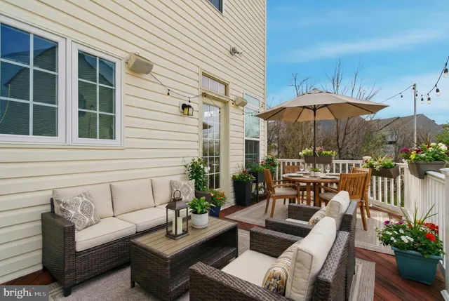 a view of a patio with couches under an umbrella