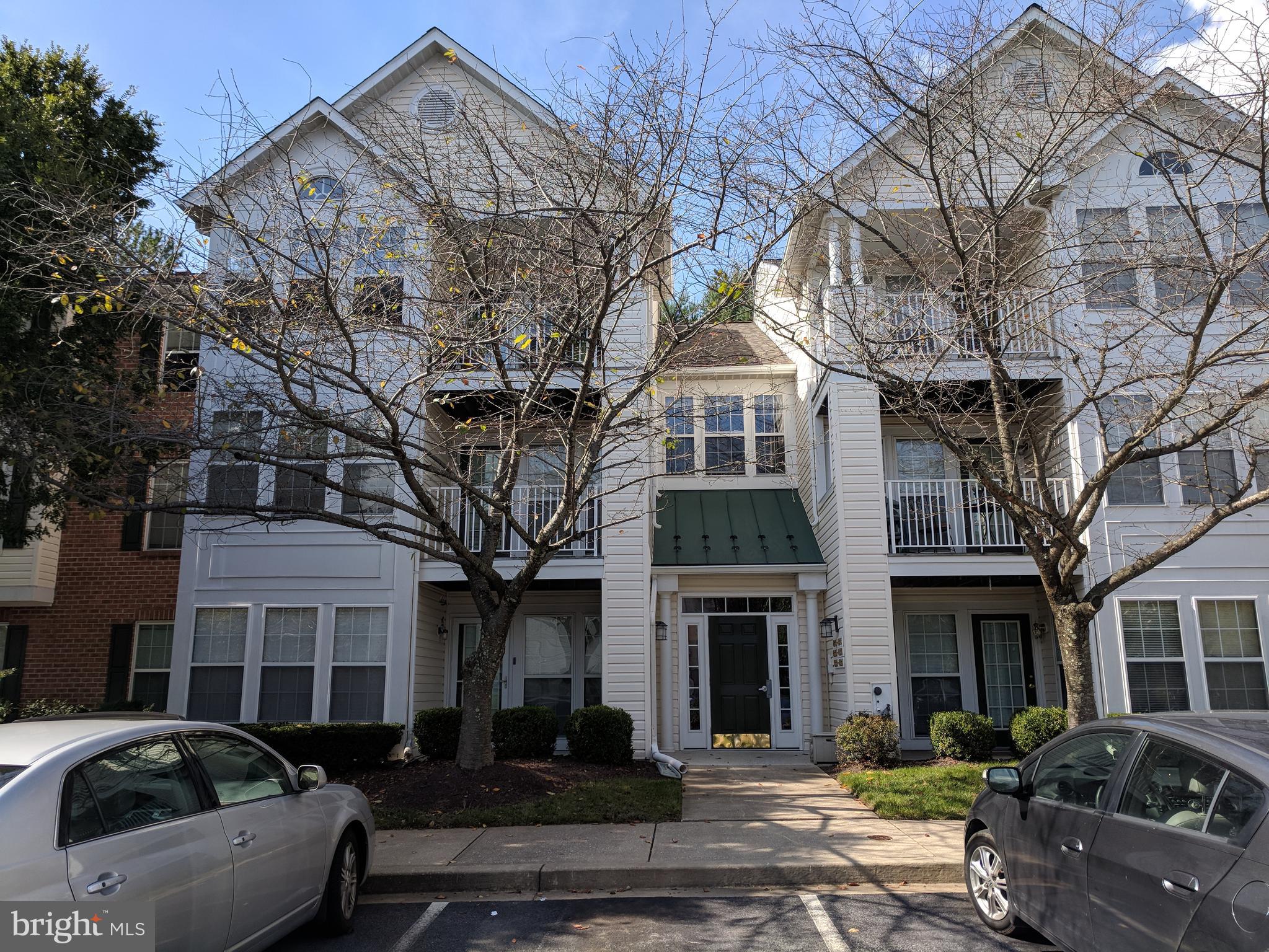 4862 Shellbark Road, Unit F Owings Mills, MD 21117 - Photo 1 of 20 a front view of a building with cars parked