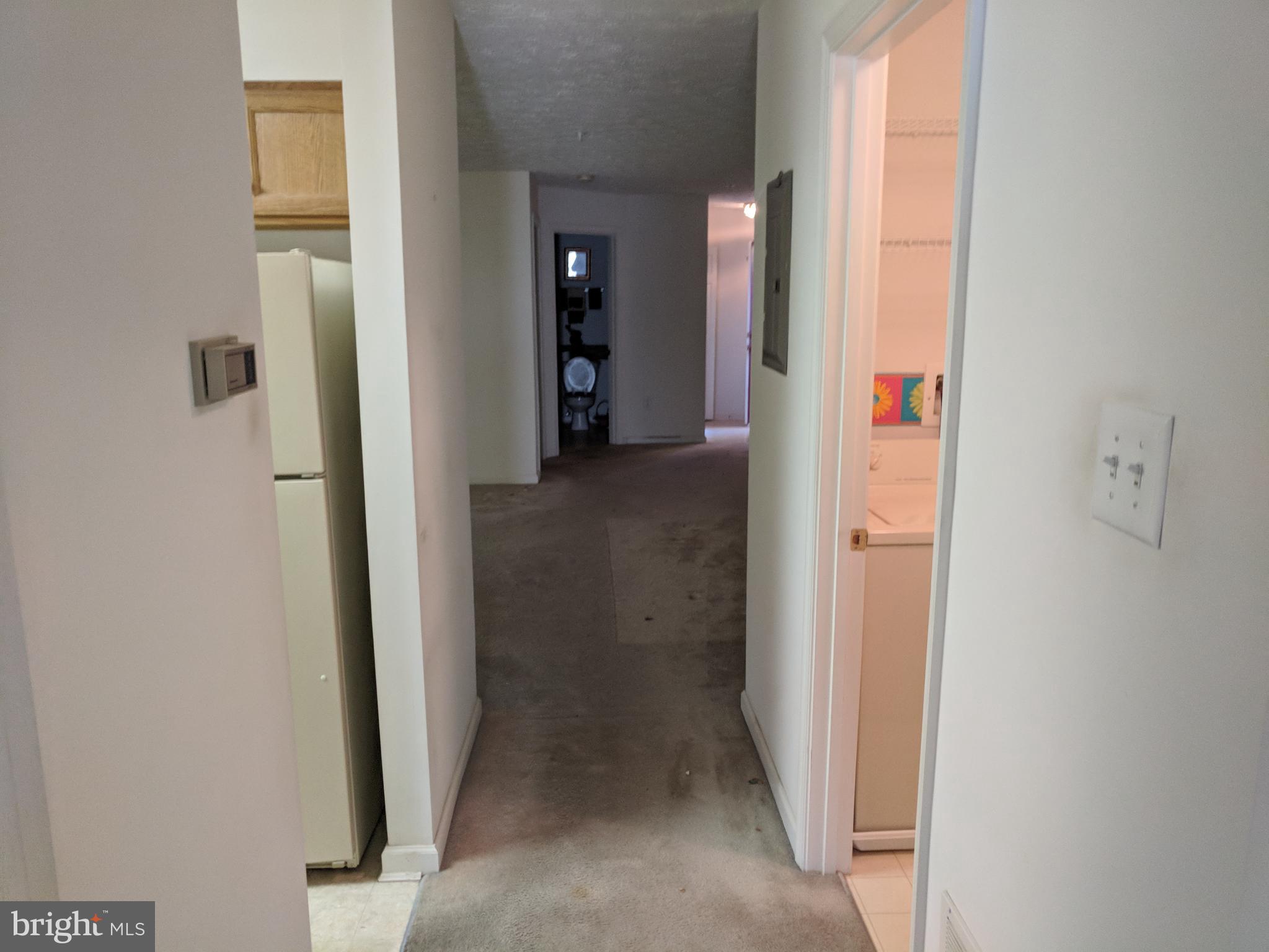 4862 Shellbark Road, Unit F Owings Mills, MD 21117 - Photo 11 of 20 a view of a hallway with wooden shelves