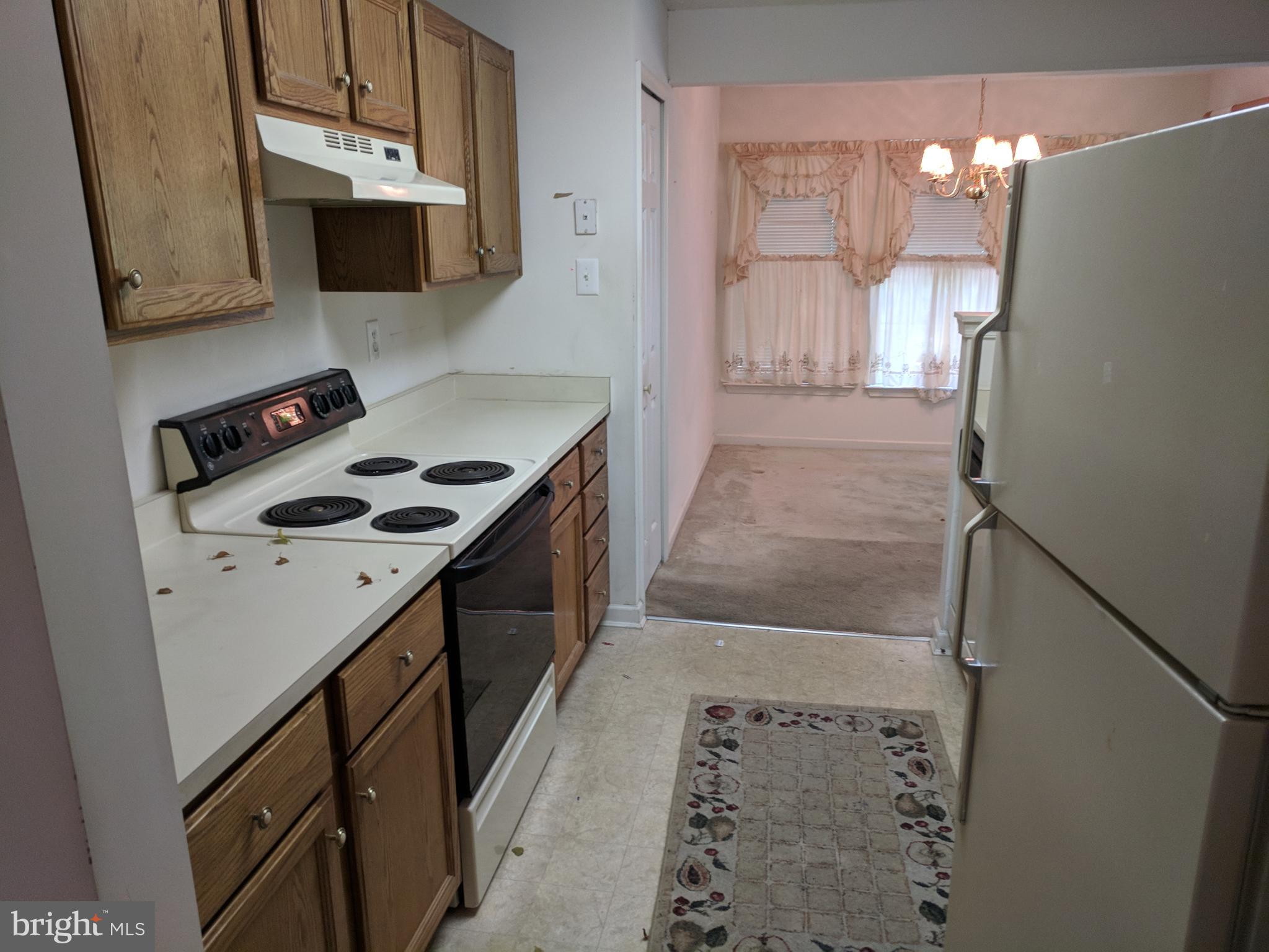 4862 Shellbark Road, Unit F Owings Mills, MD 21117 - Photo 12 of 20 a kitchen with a stove and a microwave