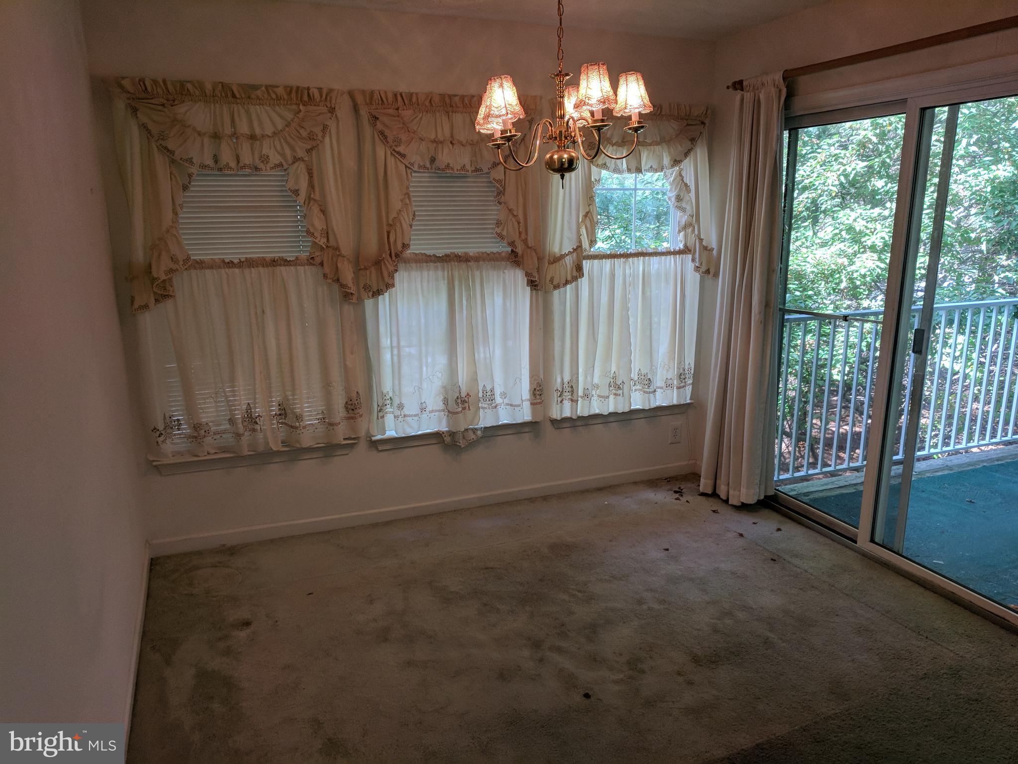 4862 Shellbark Road, Unit F Owings Mills, MD 21117 - Photo 15 of 20 a view of a room with wooden floor chandeliers and kitchen