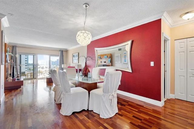 a living room with furniture dining table and a wooden floor