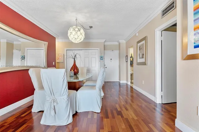 a view of a dining room with furniture wooden floor and a chandelier