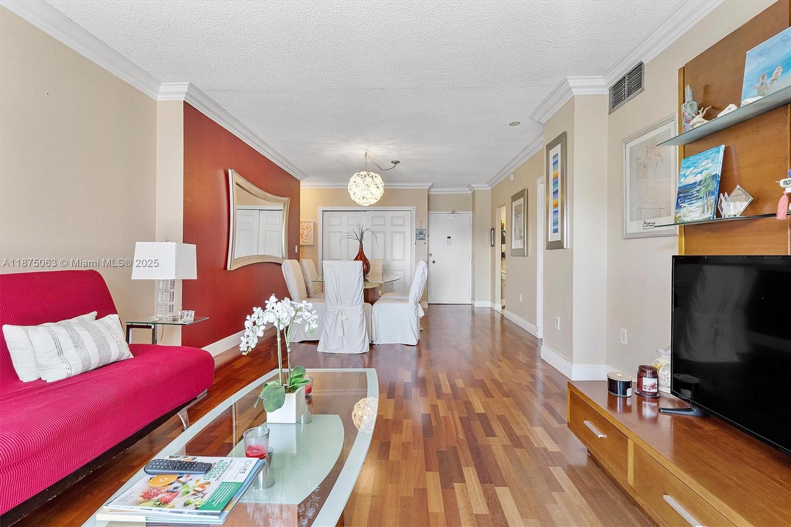 1980 South Ocean Drive, Unit 7N Hallandale Beach, FL 33009 - Photo 5 of 12 a living room with furniture and a flat screen tv