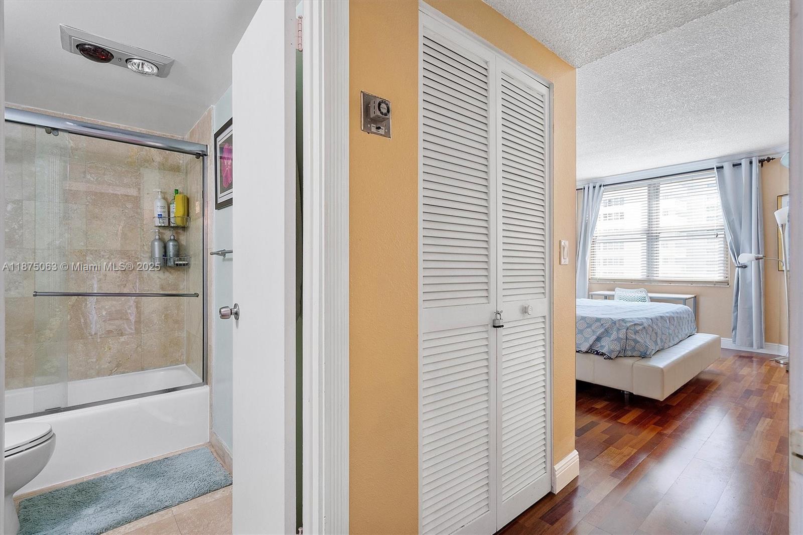 1980 South Ocean Drive, Unit 7N Hallandale Beach, FL 33009 - Photo 7 of 12 a bedroom with wooden floor and a bathroom