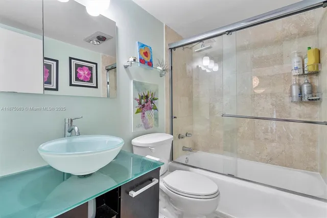 a bathroom with a sink mirror bathtub and toilet