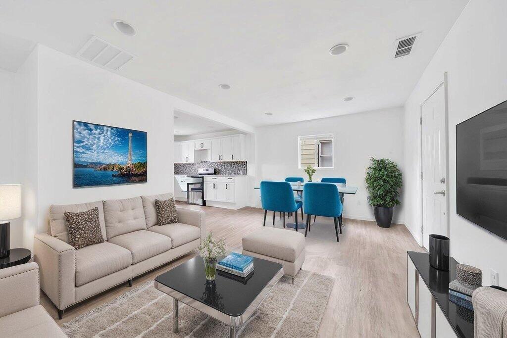 5247 West 3rd Avenue Gary, IN 46406 - Photo 2 of 16 a living room with furniture flat screen tv and a refrigerator