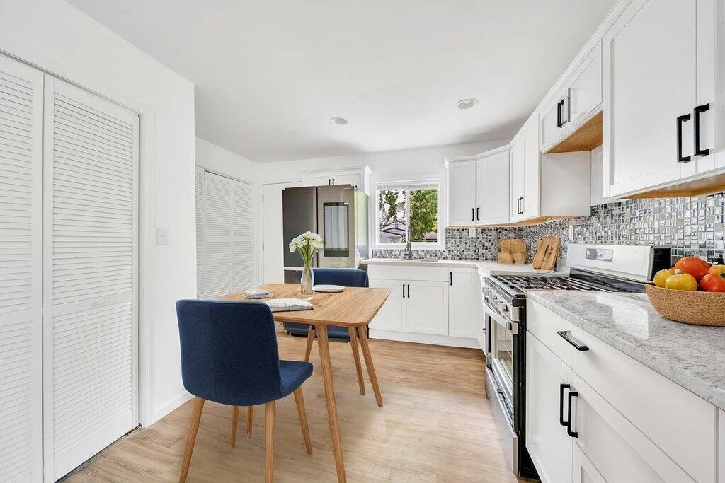 5247 West 3rd Avenue Gary, IN 46406 - Photo 7 of 16 a kitchen with a table chairs and a refrigerator
