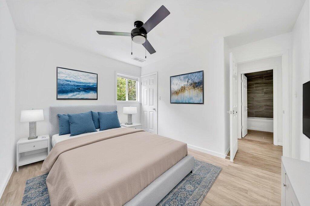 5247 West 3rd Avenue Gary, IN 46406 - Photo 10 of 16 a bedroom with a large bed and a chandelier