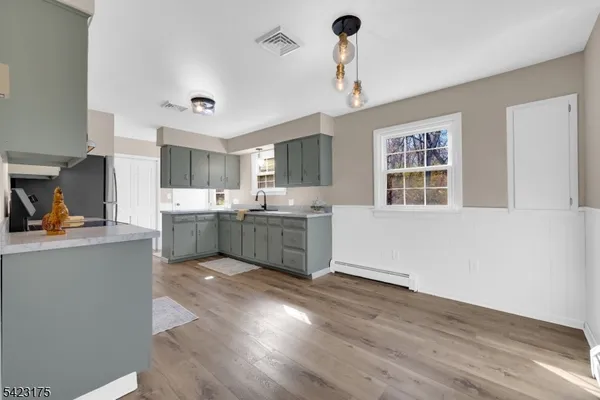 a kitchen with a sink cabinets and window
