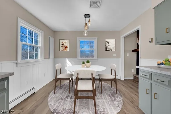 a view of a dining room with furniture window and wooden floor