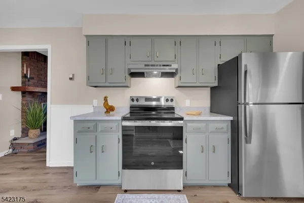 a kitchen with stainless steel appliances granite countertop a refrigerator stove and sink