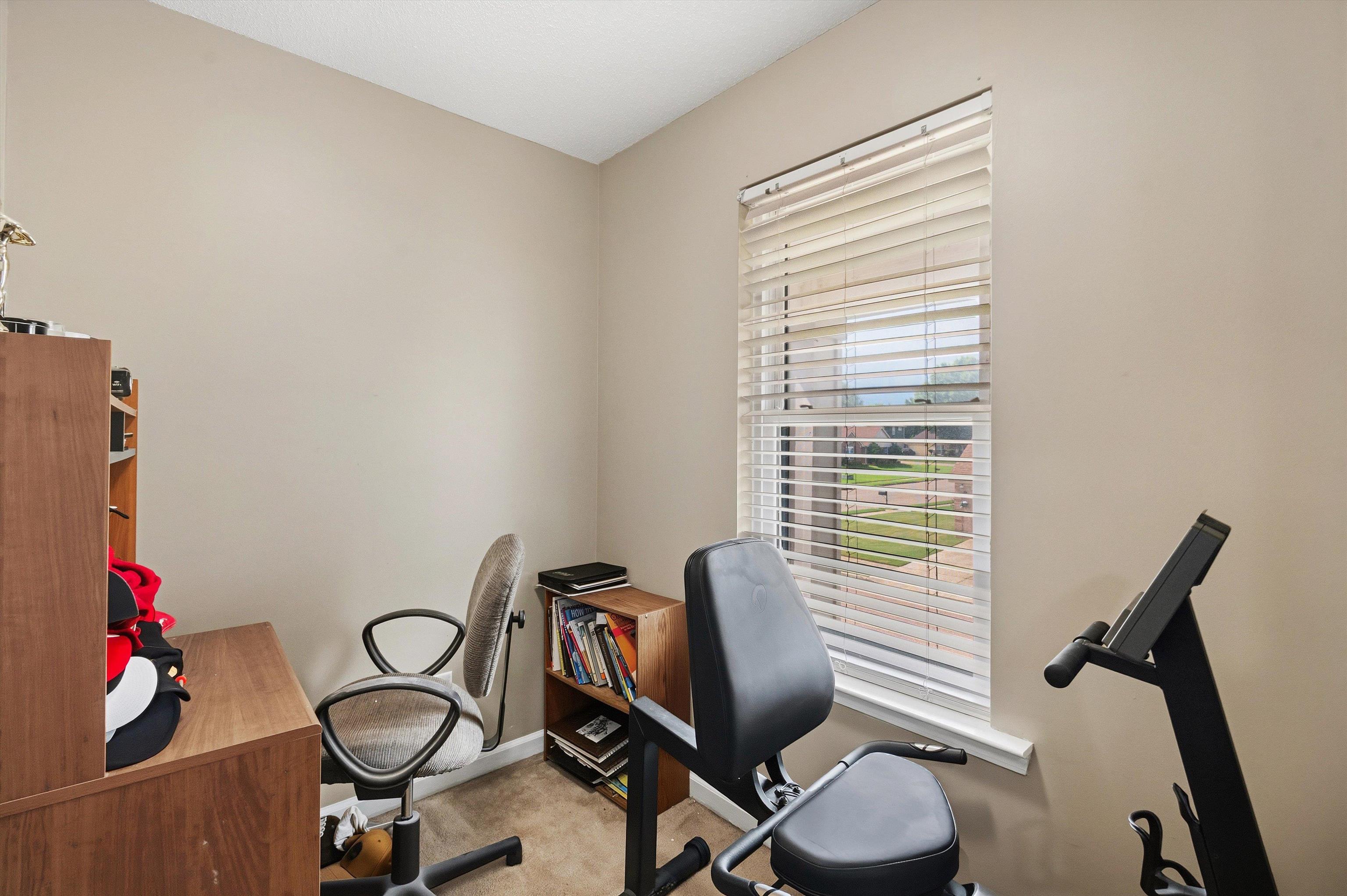 7779 Windy Willow Road Memphis, TN 38125 - Photo 20 of 30 Neutral tone walls with a single window featuring horizontal blinds
