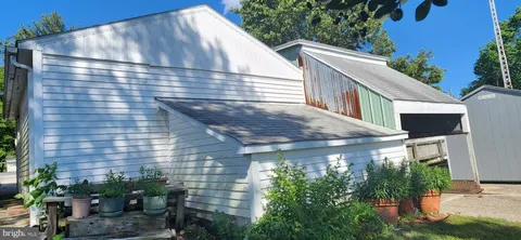 a backyard of a house with a tree