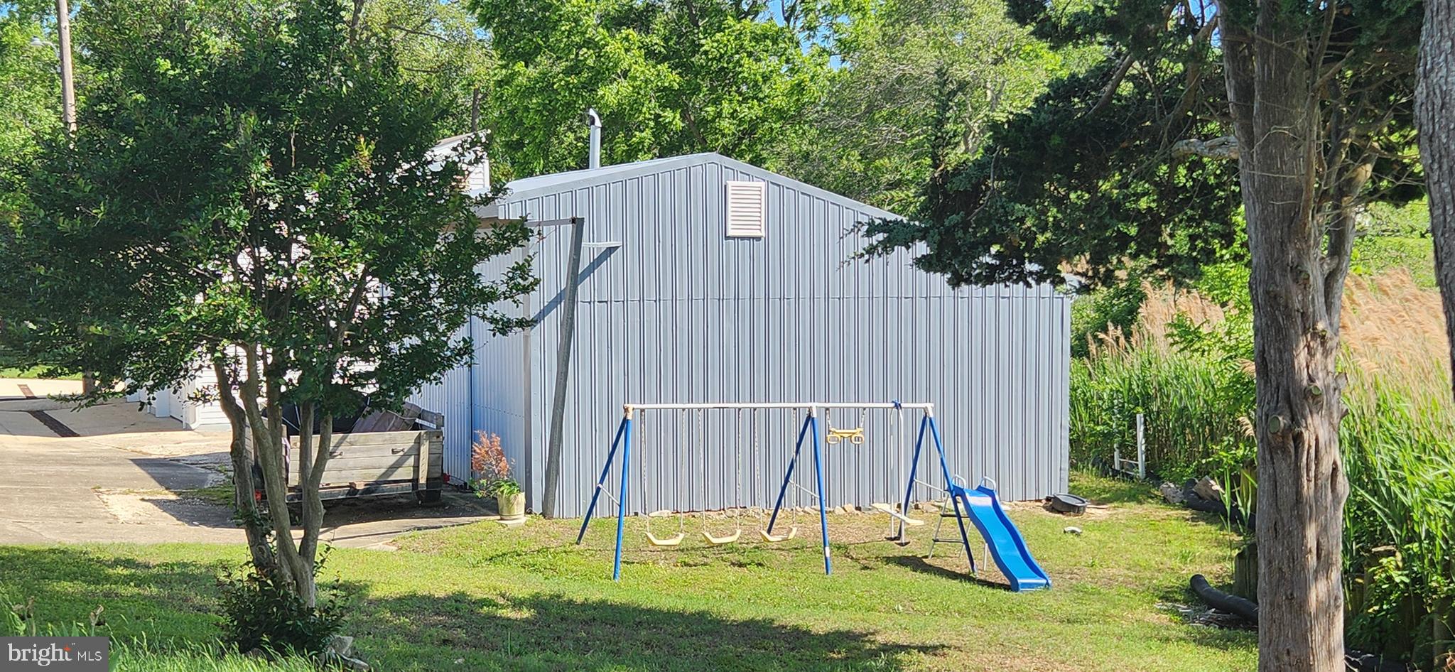 28050 Possum Point Road Millsboro, DE 19966 - Photo 13 of 47 a backyard of a house with a tree