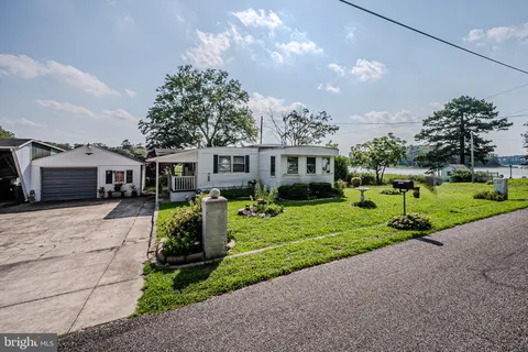 a front view of a house with garden and porch