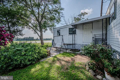 a view of a livingroom with furniture and a window