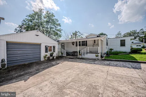 a front view of a house with a yard and a garage