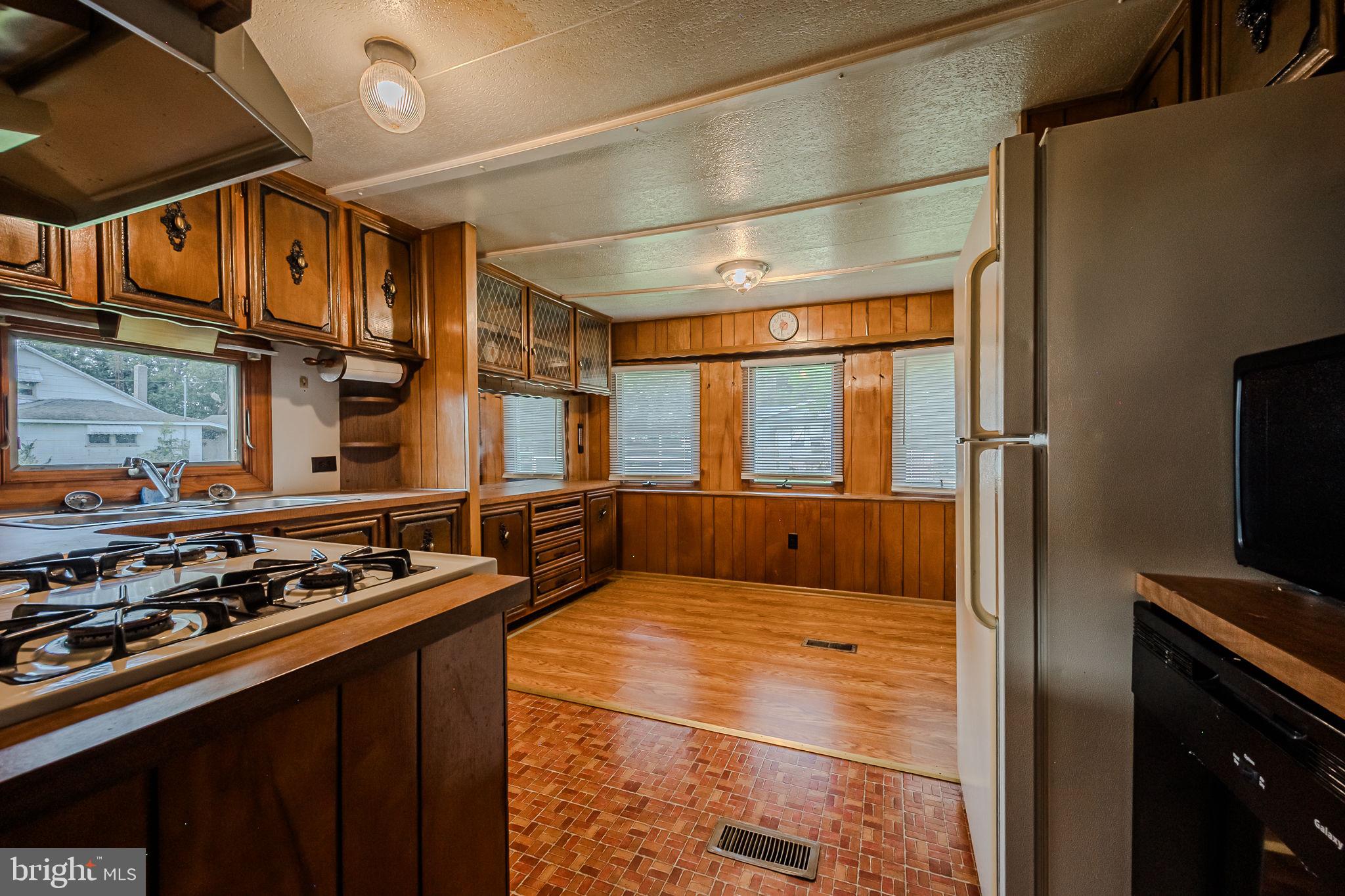 28050 Possum Point Road Millsboro, DE 19966 - Photo 29 of 47 a kitchen with stainless steel appliances granite countertop a stove and a refrigerator