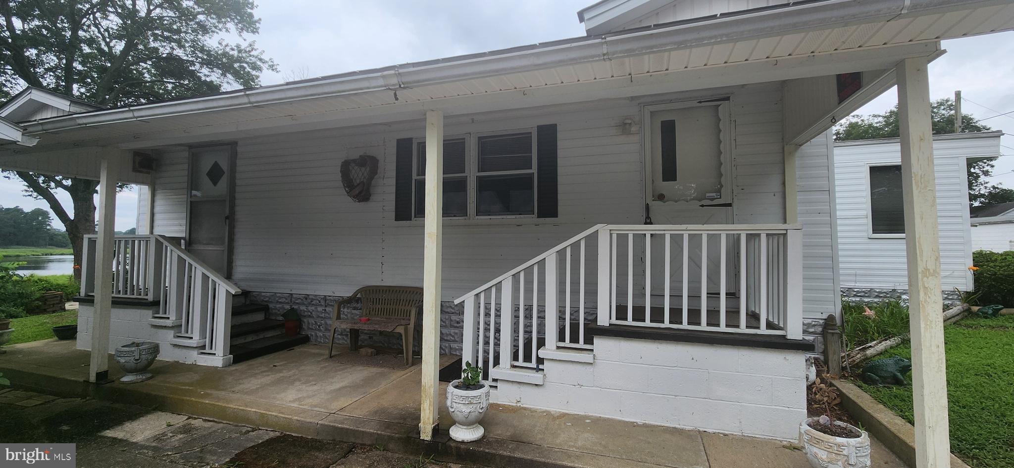 28050 Possum Point Road Millsboro, DE 19966 - Photo 3 of 47 a view of a house with backyard and porch