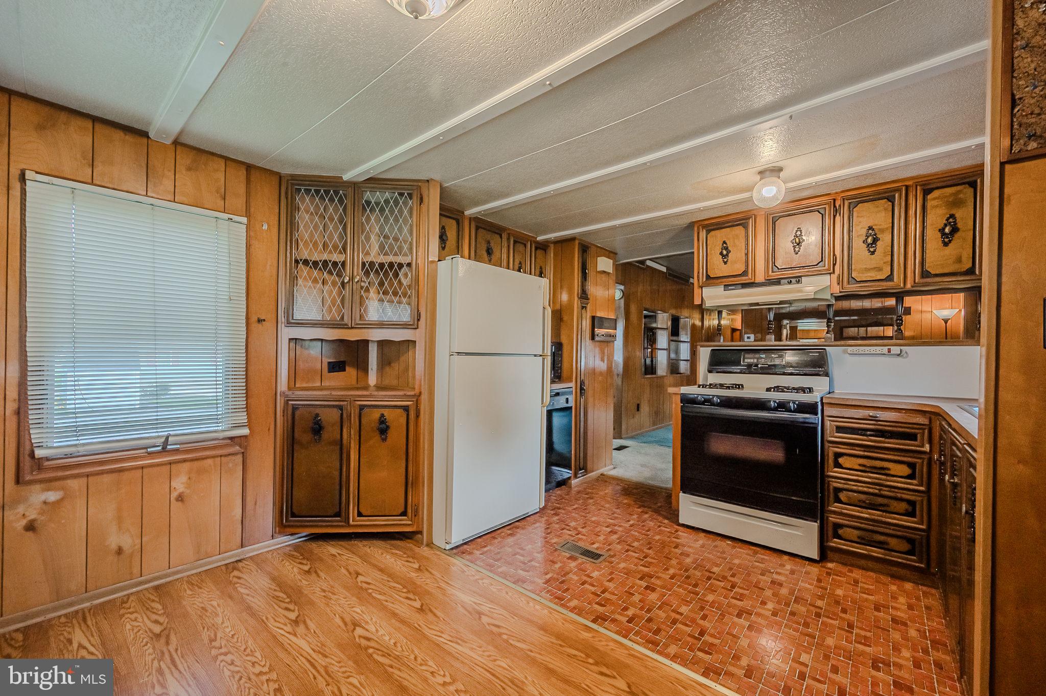 28050 Possum Point Road Millsboro, DE 19966 - Photo 32 of 47 a kitchen with stainless steel appliances granite countertop a refrigerator and a stove