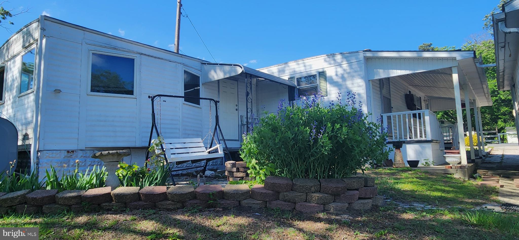 28050 Possum Point Road Millsboro, DE 19966 - Photo 9 of 47 a view of a house with a yard
