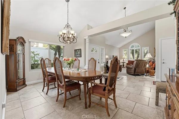 a bedroom with a bed a table and large window