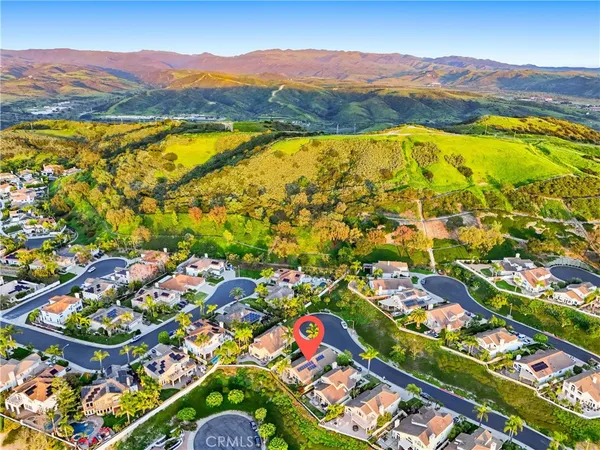 an aerial view of residential houses with outdoor space and street view