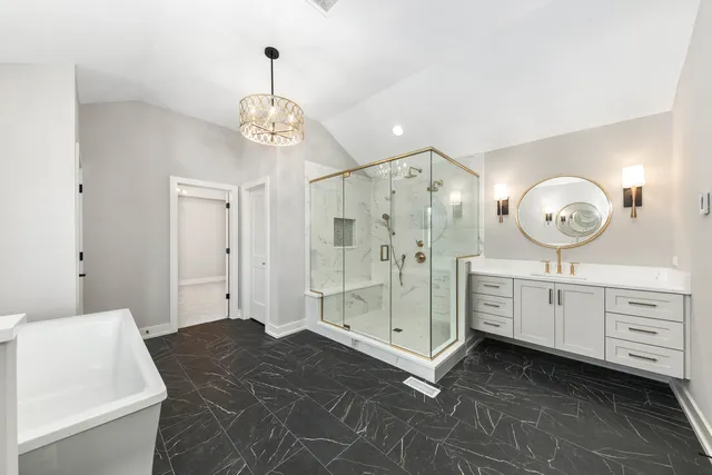 an empty room with windows and chandelier