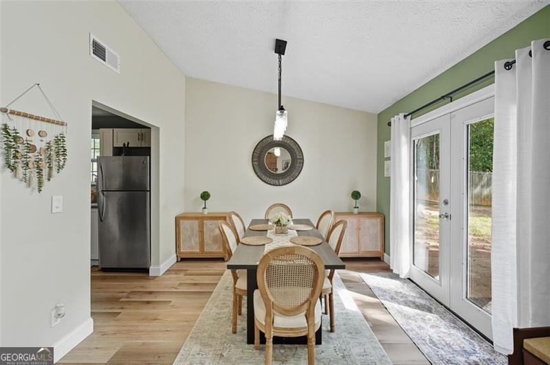 4450 Dorsett Shoals Road Douglasville, GA 30135 - Photo 12 of 36 a living room with furniture a window and a chandelier