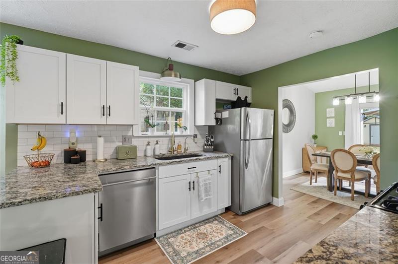 4450 Dorsett Shoals Road Douglasville, GA 30135 - Photo 16 of 36 a kitchen with stainless steel appliances granite countertop a refrigerator sink and stove