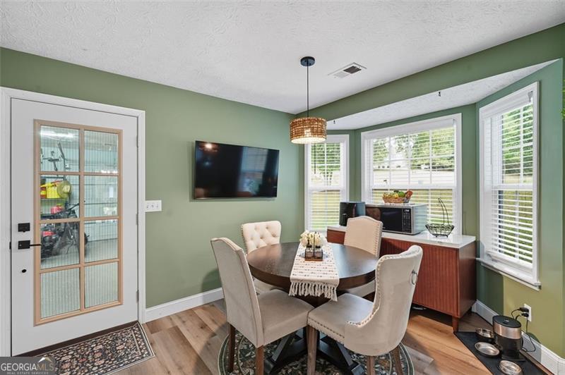 4450 Dorsett Shoals Road Douglasville, GA 30135 - Photo 19 of 36 a dining room with furniture window and wooden floor