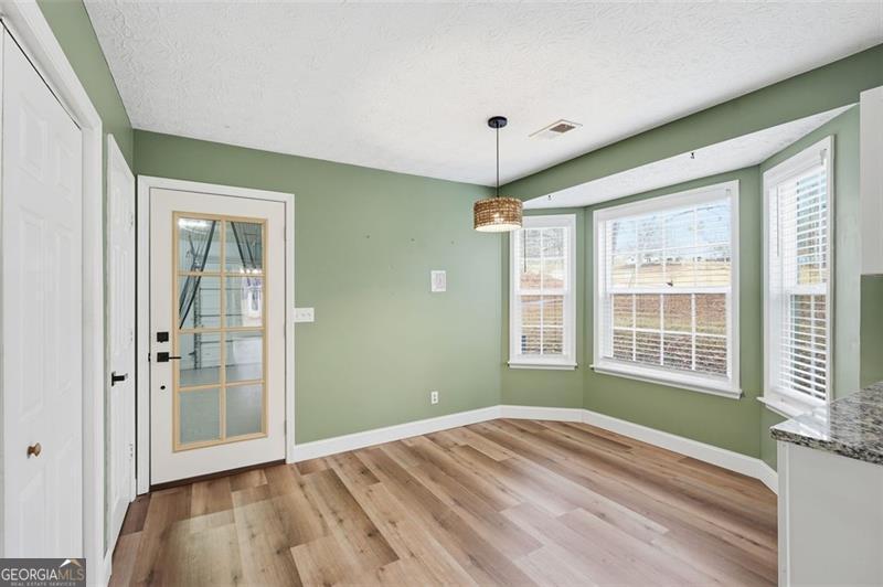 4450 Dorsett Shoals Road Douglasville, GA 30135 - Photo 20 of 36 a view of empty room with wooden floor and fan
