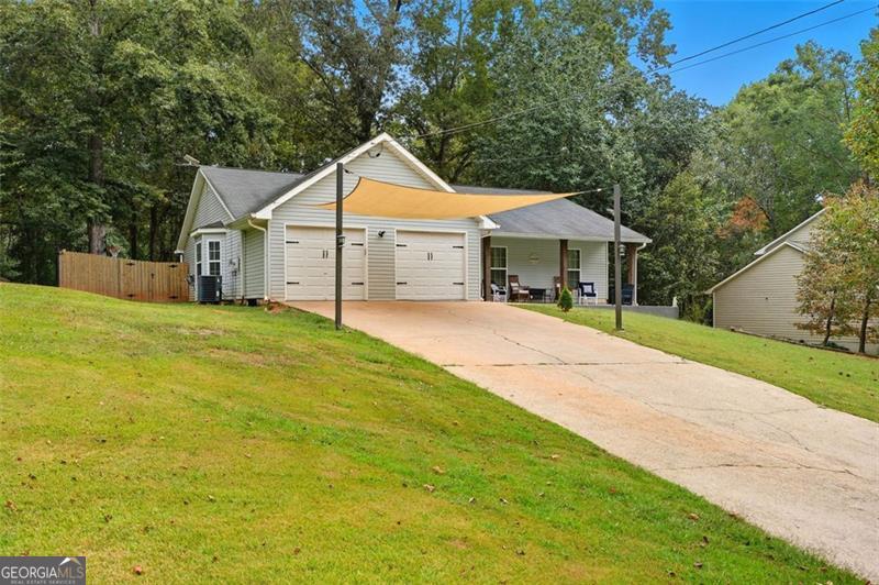 4450 Dorsett Shoals Road Douglasville, GA 30135 - Photo 2 of 36 a front view of a house with a yard and garage
