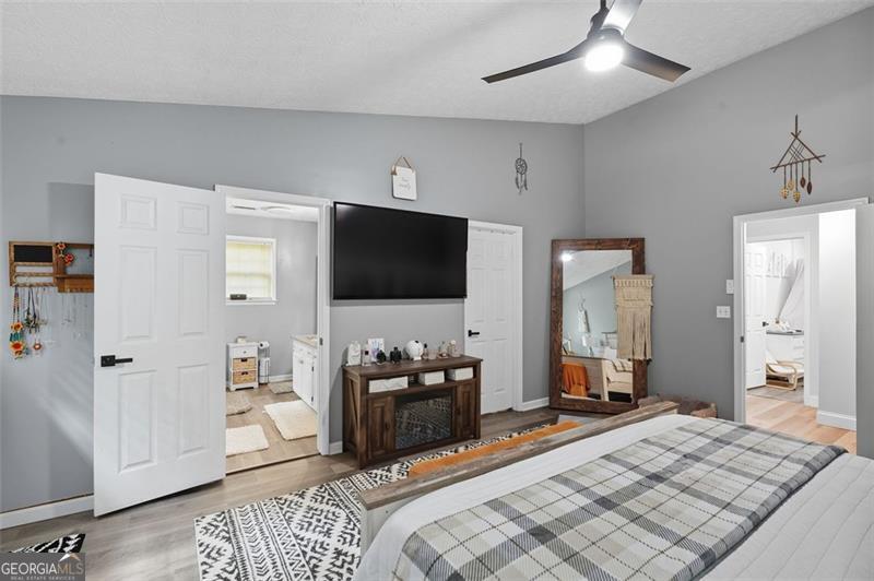 4450 Dorsett Shoals Road Douglasville, GA 30135 - Photo 22 of 36 a bedroom with a bed and a flat tv screen on dresser