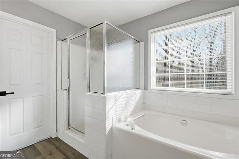 4450 Dorsett Shoals Road Douglasville, GA 30135 - Photo 25 of 36 a bathroom with a bathtub and a shower